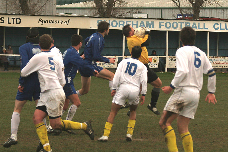 Darren Lambert clutches the ball with Danny Gainsford rushing in
