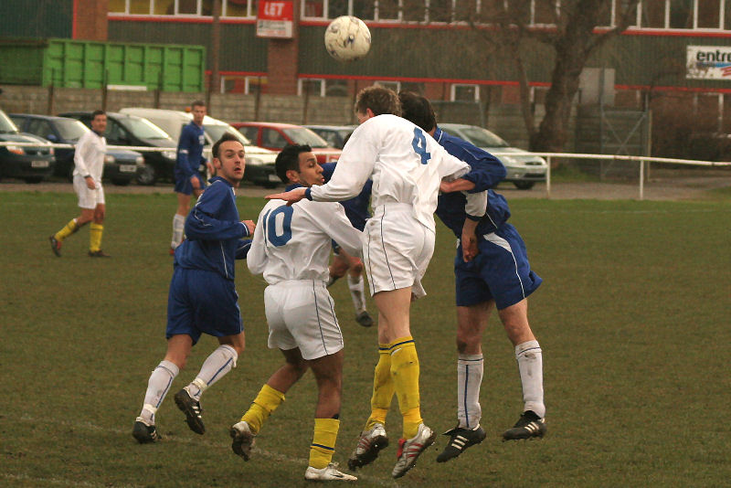 Christian Troak and Phil Williamson (4) go for the header as Shoreham's Paul Lockhart waits for the ball to drop to him
