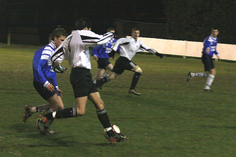 Chris Hibberd on the ball as Lee Farrell runs on
