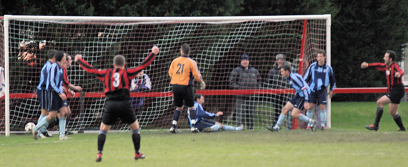 Pete Christodolou (right) sees his shot deflected for Wick's opening goal

