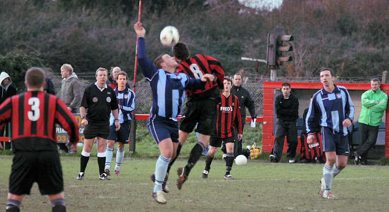 Steve Morris and Marc Cooper (8) jump for a header
