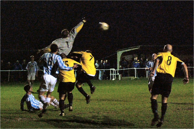 Worthing United keeper Dean Fuller punches clear from Mark Price (15) and Grant Vanson (7)
