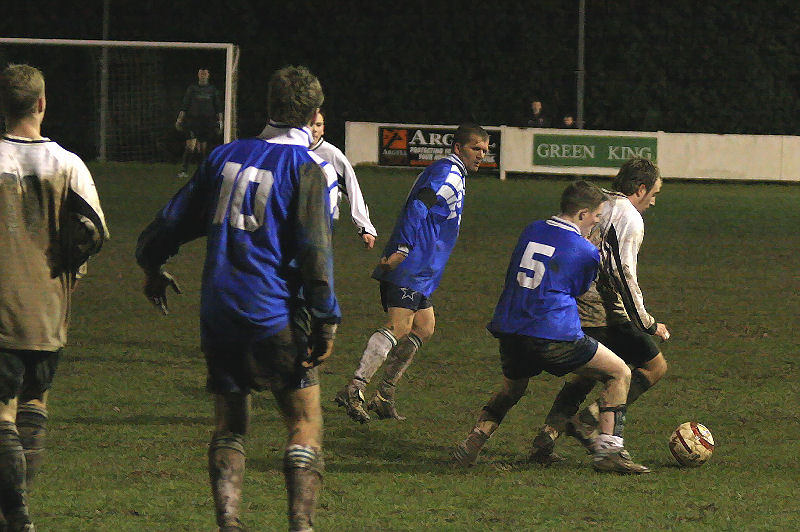 Josh Biggs is closely marked by Darren Hickman with Paul Thomas and Matt Osbourne (10) on hand
