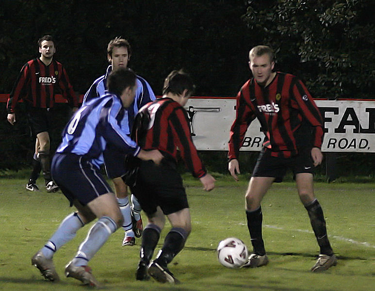Kieron Howard goes on a run watched by Dave Ward (6) and Paul Hodder
