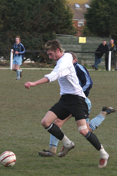 Dan McLaughlin takes the ball past Michael Turville
