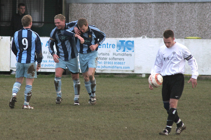 East Grinstead captain Dave Gellatly and Ben Burns (9) congratulate Drew Cooney on the opening goal
