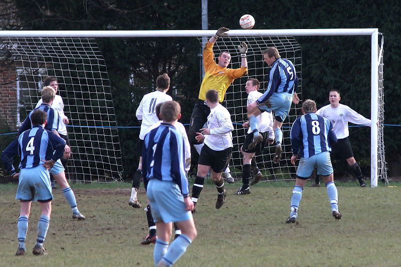 Andy McCarthy tips the ball away from Drew Cooney (5) ...
