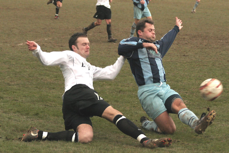 Sub Dave Walker (left) beats Steve Moore (?) and loops the ball over the keeper from a tight angle for the East Preston winner
