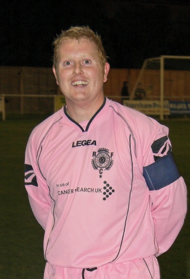 Rustington captain Russell Tomlinson 'models' the new away strip adopted in support of Cancer Research
