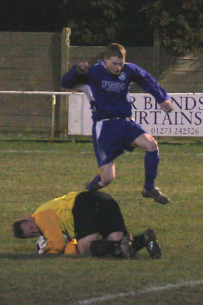 James Highton hurdles Graham Leach as he grabs the ball

