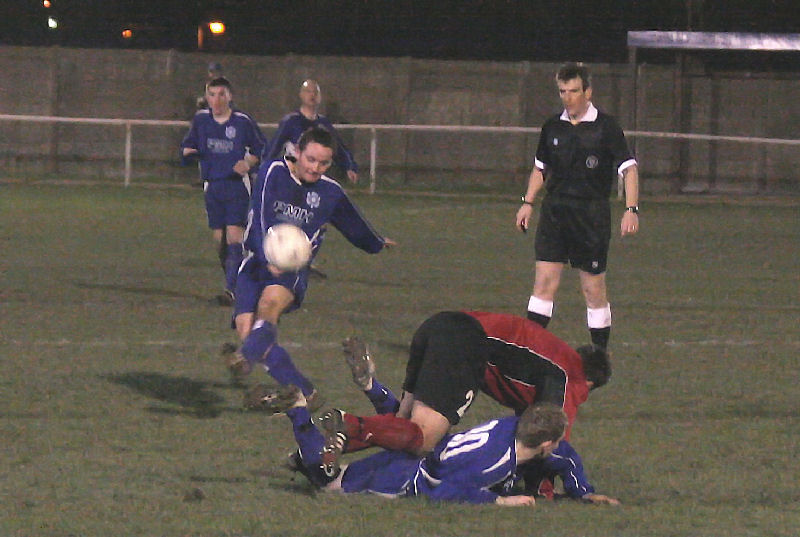 Dave Oakes hooks the ball away as Danny Gardiner (2) tangles with James Highton (10) 
