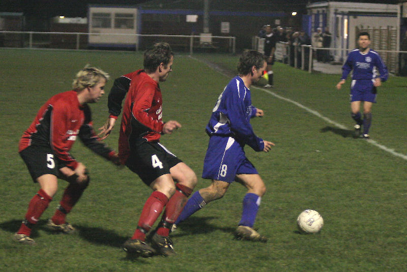 Dave Oakes is closely watched by Stuart Mouland (5) and Mark Chalk (4)
