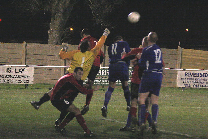 Graham Leach punches the ball off the head of Craig Cox(11)
