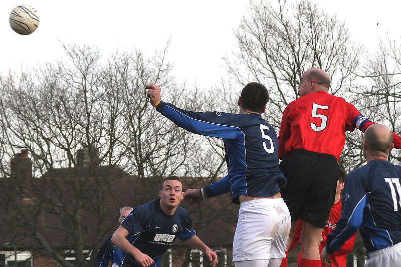 Tony Miles (5 red) beats Craig Bishop (5 blue) to this header
