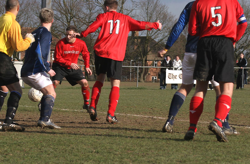 Neither Jan Miller nor Danny Curd (11) can nudge the ball home in a crowded penalty area
