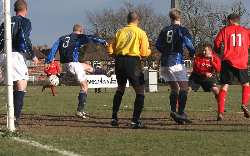 Wick go close but Ian Meek (3) clips the ball away
