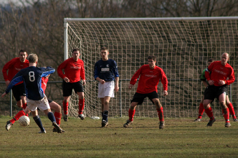 An attempt on goal by Dean Chamberlain (8) is shut out by Wick defenders 
