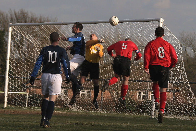 Crow's captain Craig Bishop and keeper Kush Movaffagh do enough to stop Tony Miles (5) snatching a header
