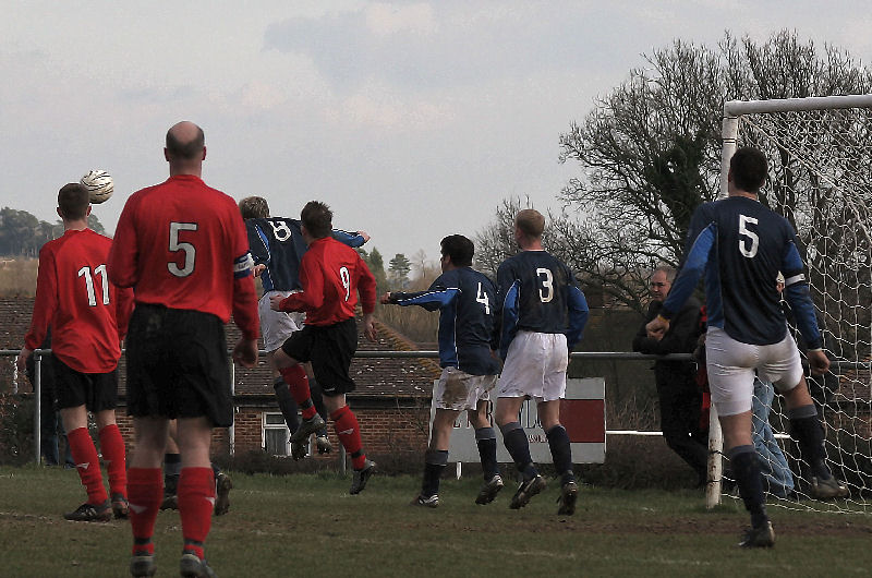 Wick pile on some late pressure but Dean Chamberlain (8) clears
