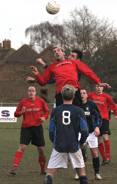 Pete Christodolou climbs above Craig Bishop to win this header
