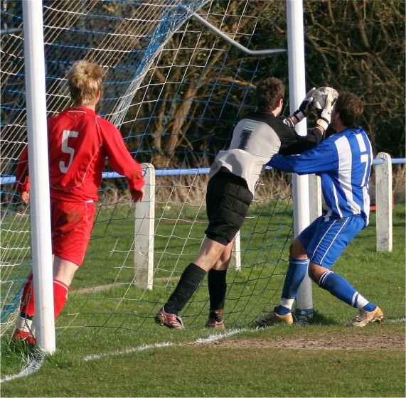 Sam Joyce gets to the ball before Ian Woods
