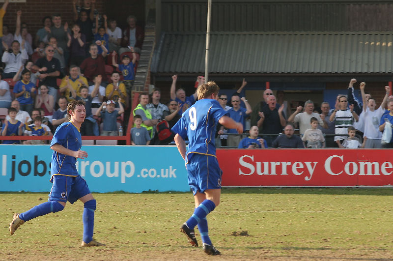 The injured Richard Butler manages to get on to a through ball and beat Luke Burton for his second goal watched by Rob Ursell
