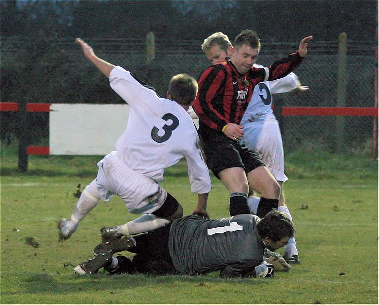 Keeper Mark Oldroyd, Max Dyer (3) and Mark Reeves (5) combine to stop Danny Curd
