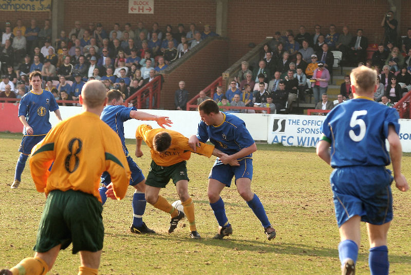 Horsham's ex Don Jamie Taylor is tackled by Jon-Barrie Bates and Joe Vines
