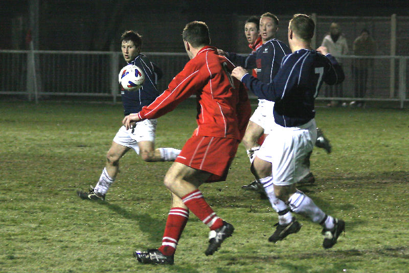 Midhurst's Chris May on the ball followed by Andy Johnson (7)
