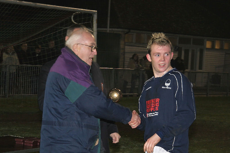 Wealden's Darren Gearing receives his Man of the Match award from Peter Strange, the President of the SCFL
