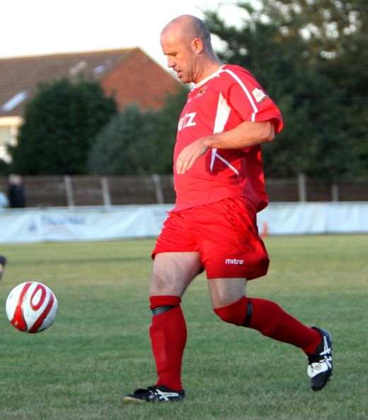 Scott Avory, under a challenge from Chris Morrow really gives the ball some punishment
