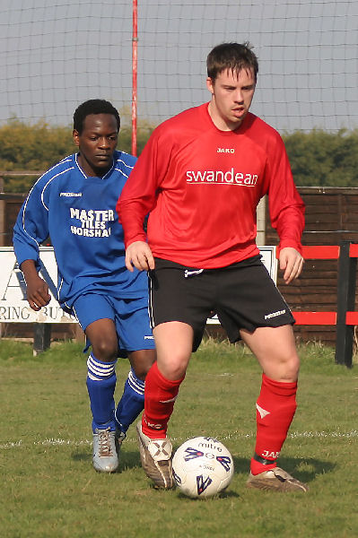 Stuart Bennett is closely tracked by Christian Chimutengwende
