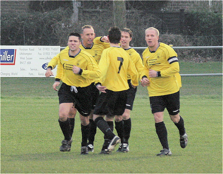 ... and Littlehampton players congratulate Ben Torode on hitting the equaliser soon after
