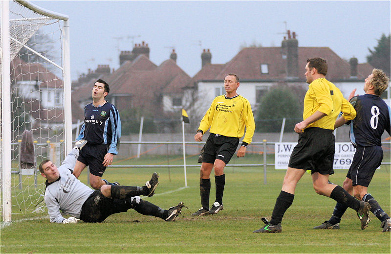 Wes Hallett pushes a Ringmer attempt over the bar as Dominic Shepherd arrives at the far post 
