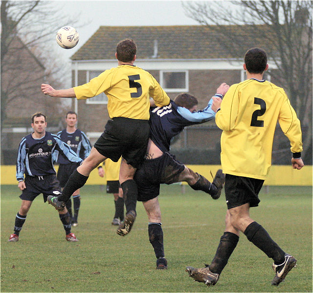 Barry Pidgeon (5) beats Gavin Jones to a header
