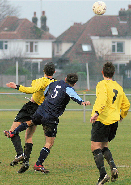 Mickey O'Callaghan (5) challenges Des Guile with Adam Hunt (7) looking on
