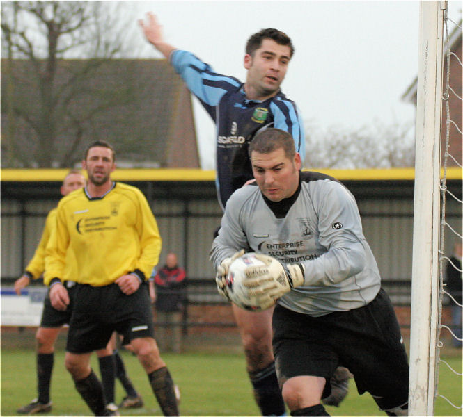 Wes Hallett grabs the ball with Dominic Shepherd putting on the pressure
