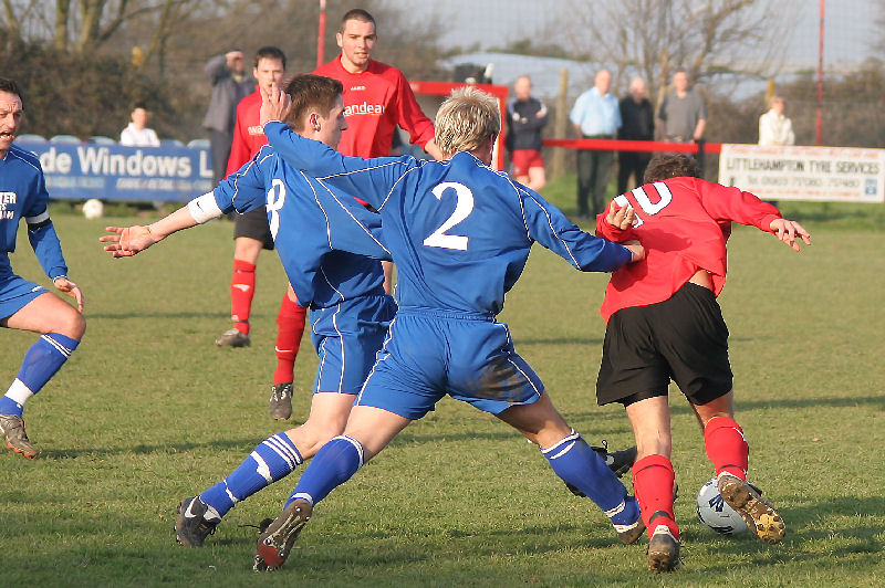 Tom Manton (10) is "double tackled" by Luke Tarrant (8) and Luke Ringrose (2)
