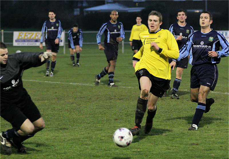 This run by Phil Turner is about to be stopped by Ringmer's sub keeper Gary Trott
