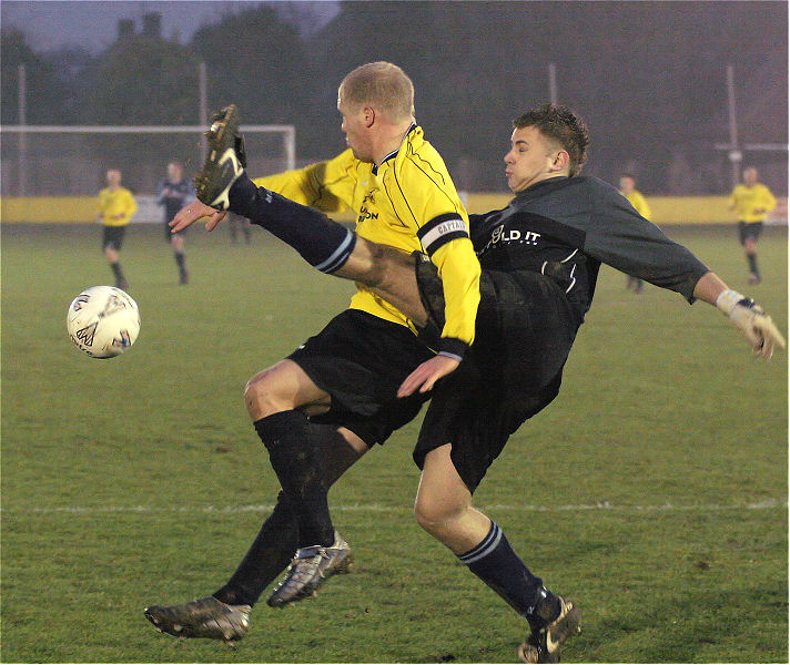 Gary Trott stretches to knock the ball away from Steve Davies
