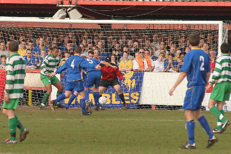 Jon-Barrie Bates and Steve Butler cannot force the ball home and Will Jenkins clears
