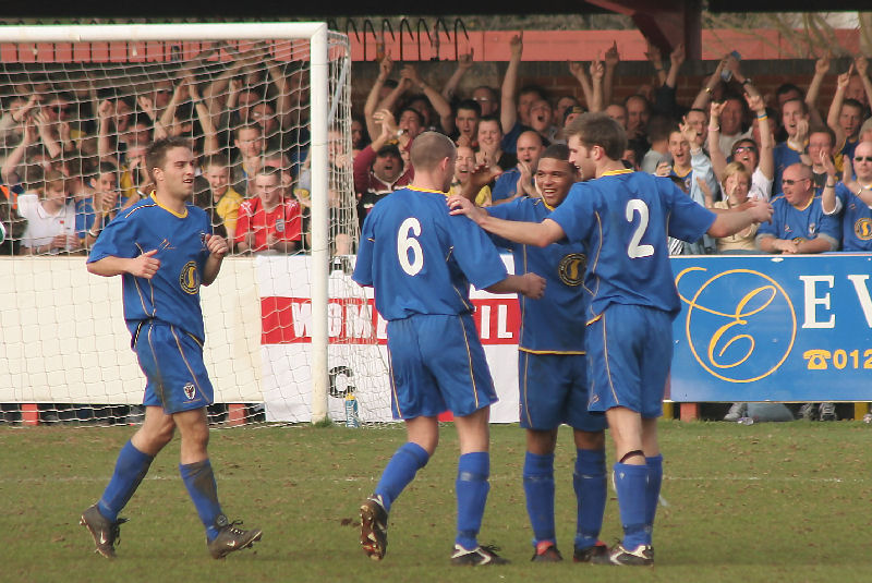 Leon McDowall is congratulated by Mark Cooper (6) and Anthony Howard (2) 
