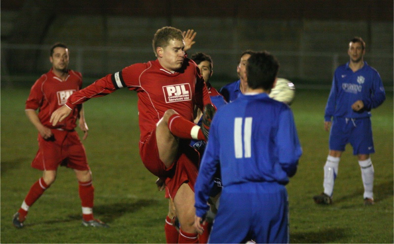 Mark Probert hacks the ball away from Terry Withers
