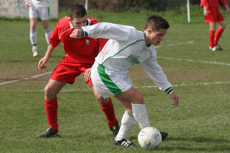 Scott Murfin on the ball shadowed by Ashley Marsh
