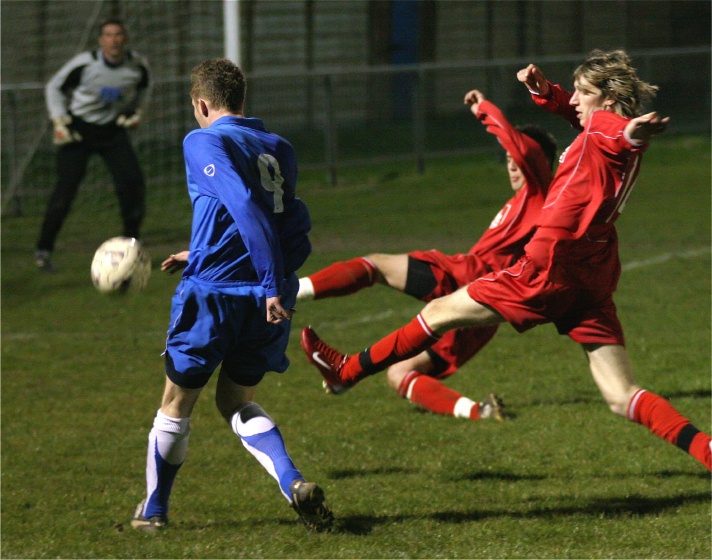 This Andy Smart shot is cut out by two defenders
