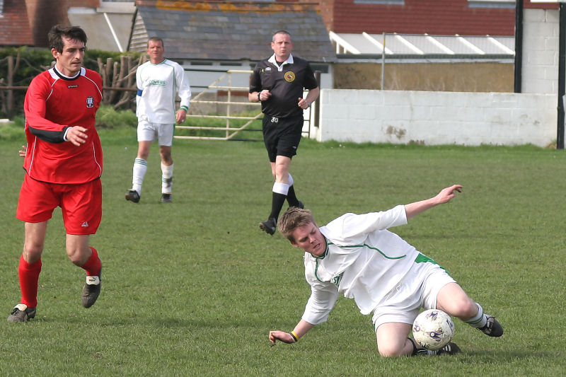 Darren Hickman slides in to win the ball
