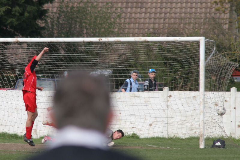 The referee's assistant has a good view as James Laing celebrates his equaliser for Hassocks
