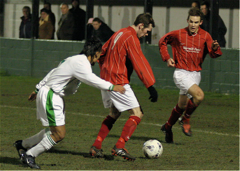 Andy Boxall on the ball, Chris Green overlaps with Belal Miah close up
