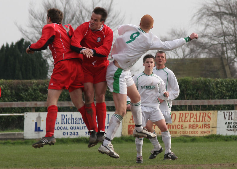 Stuart Faith (8), Nick Newman and Scott Tipper (9) challenge for a header
