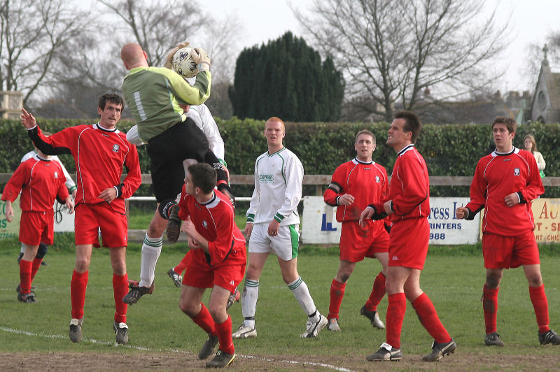 Joel Harding makes an important catch under a strong challenge from Peter Robertson
